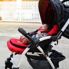 cute baby boy laughing happy in child stroller