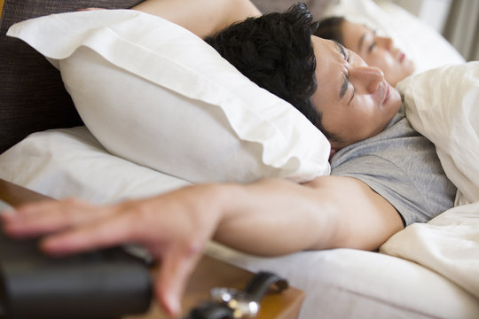 Young couple sleeping on bed