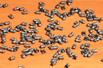 Air gun pellets on wood background