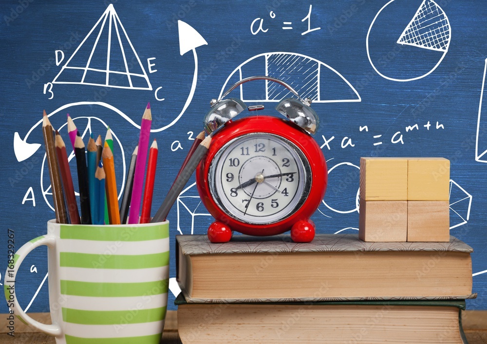 Poster objects on desk foreground with blackboard graphics of math equa