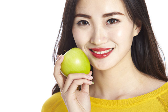 asian woman with a green apple
