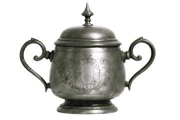 An old silver metal sugar bowl with a lid and ornament. Metal punctles with scratches and patina.