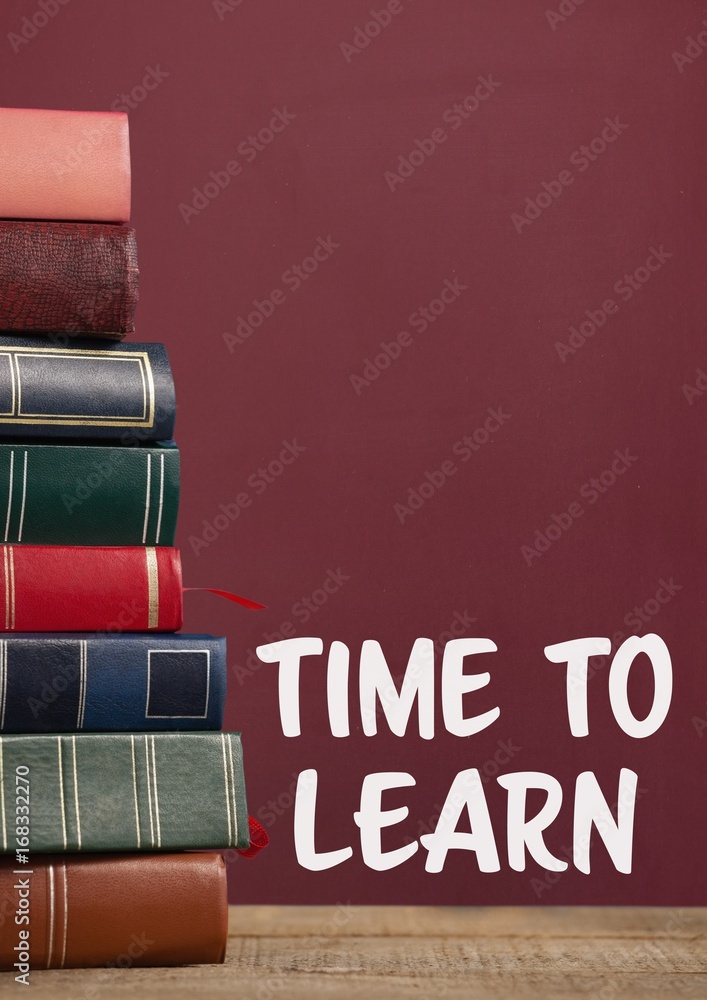 Poster books on the table against red blackboard with time to learn tex