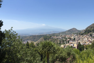 Fototapeta na wymiar The town of Taormina in Sicily with the mount Etna in the background