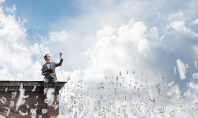 Young businessman or student studying the science and symbols fly around