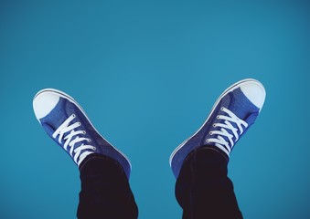 Blue shoes on feet with blue background