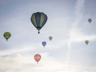 Ballons drift away in an earl morning lift