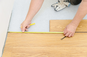 Fototapeta na wymiar Installation of a laminate floorboard.