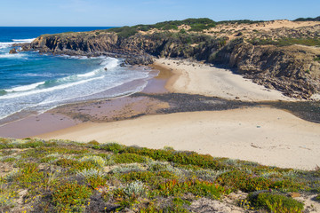 Beach with cliffs and vegetation in Almograve