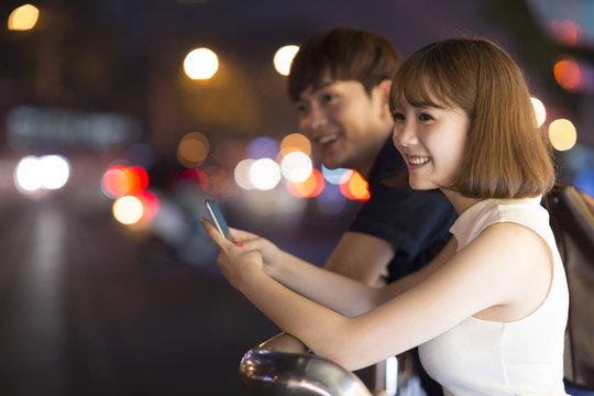 Young couple waiting at the bus stop