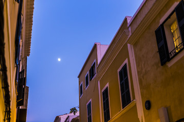 Fototapeta na wymiar Moonlight on a night urban scene on a dark street