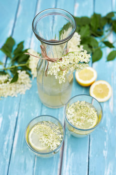 Two glasses of elderflower lemonade and carafe, top view