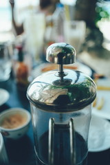 French press coffee maker in a cafe bar. close up image toned image selective focus