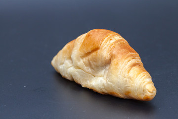 tuna croissant on black background