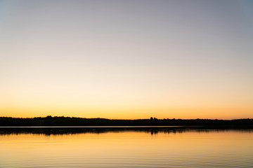 Fototapeta na wymiar Sunset on the lake in the wilderness
