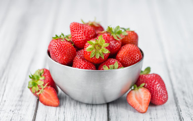 Portion of Strawberries on wooden background, selective focus
