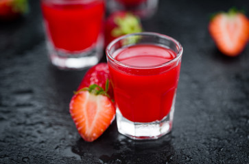 Rustic slate slab with Strawberry liqueur, selective focus