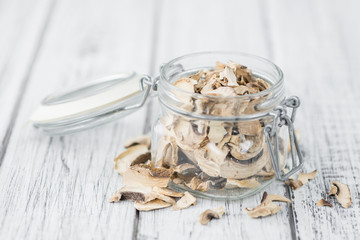 Portion of Dried Mushrooms on wooden background, selective focus