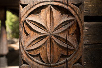 aged wooden Pillar with flower carving