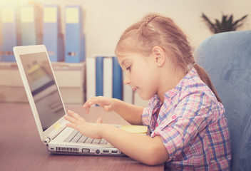 Little girl working on the laptop