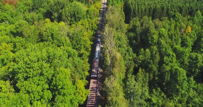 Short Train on a long journey through scenic rural America, aerial view.
