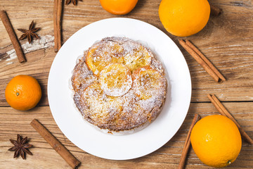 Orange cake on the wooden background