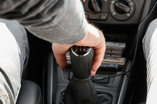 Closeup of male hand on gearshift stick