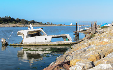 Half-sunken boat in the port