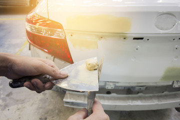 Repairing car body by puttying close up work after the accident by working sanding primer before...