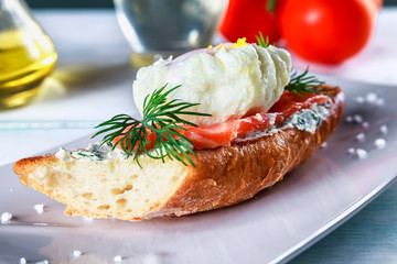 sandwich with ricotta cheese, salmon and poached egg on a plate