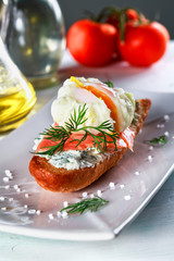 sandwich with ricotta cheese, salmon and poached egg on a plate