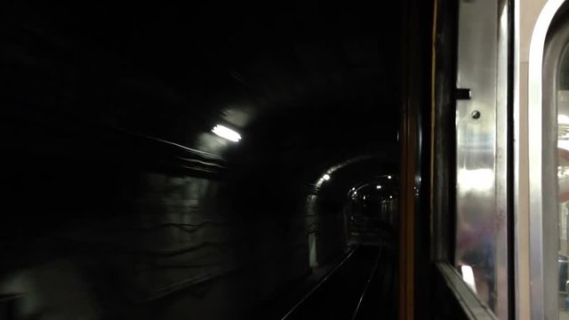 Subway moving through tunnel POV - side - train / carriage reference.