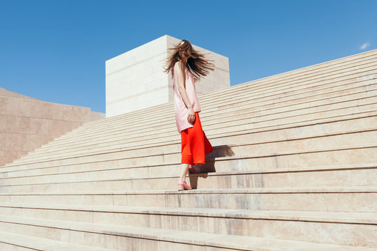 woman with red and pink clothes on the stairs