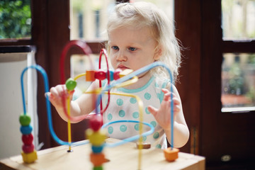 Child playing with a wooden toy
