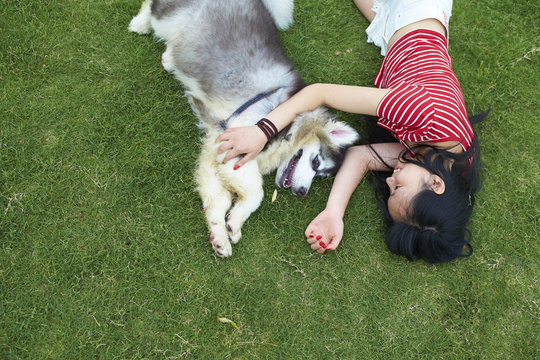 happy little asian girl with her dog outdoor