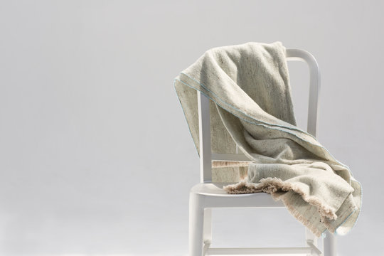 Handmade wool and bamboo blanket on a metallic chair