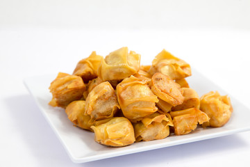 Deep fried wonton or fried dumplings cuisine on white plate