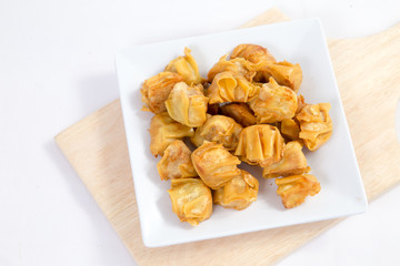 Deep fried wonton or fried dumplings cuisine on white plate