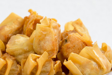 Deep fried wonton or fried dumplings cuisine on white plate