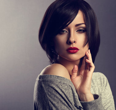 Beautiful Makeup Elegant Sexy Woman With Bob Short Hair Style And Red Lipstick Posing On Dark Shadow Background. Closeup Portrait.Toned