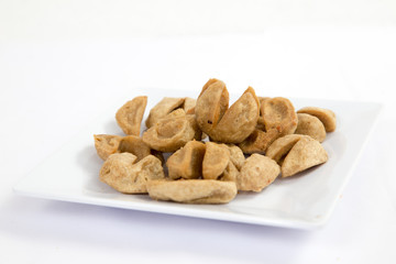 Deep fried meatballs on white plate on a table
