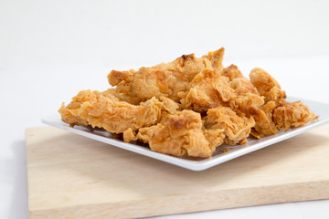 Fried crispy chicken breaded with corn flake crumbs with ketchup on wooden board.