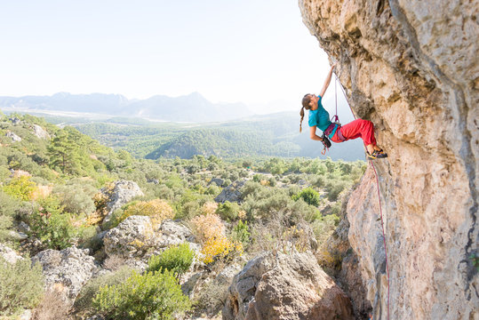 Young female rock climber on a difficult climbing route