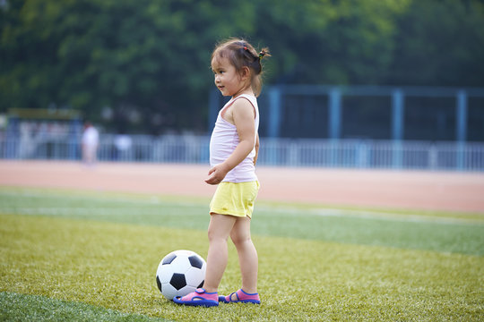 A girl playing soccer on the field
