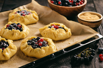 Rustic galettes with blueberries and red currants.