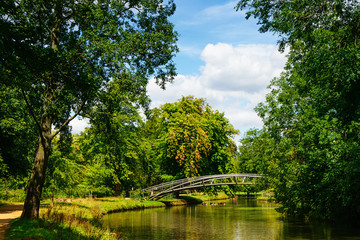 Metal bridge across river. Countryside landscape