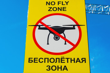 Signboard NO FLY ZONE  with a picture of a dithered droning.