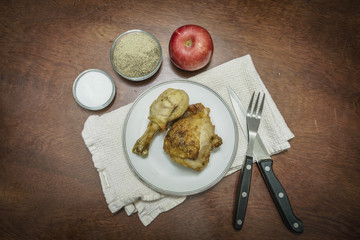 plate of delicious roast chicken with apple and seasoning
