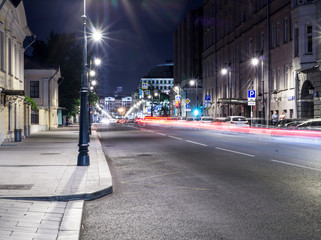 Fototapeta premium modern city street with lights and traffic at night. background, citylife.