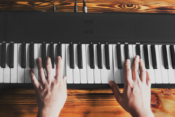 A man playing the synthesizer.